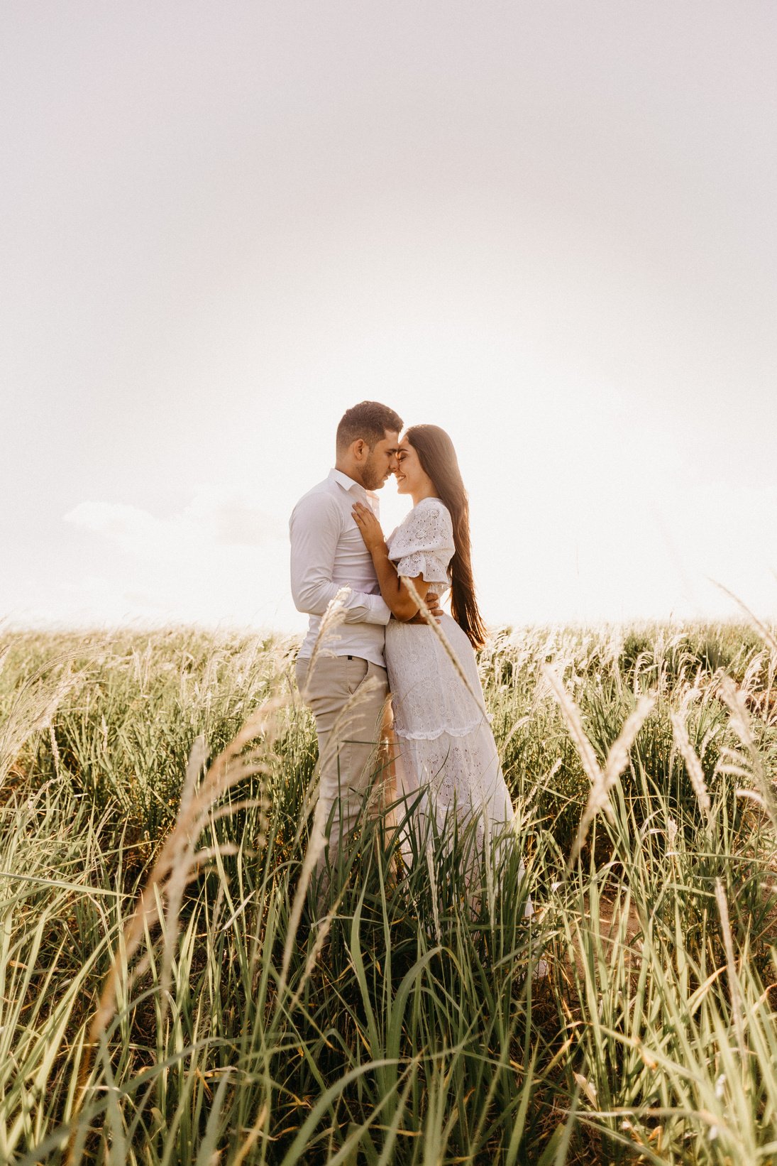 Newly Wed Couple Kissing on the Grass Field